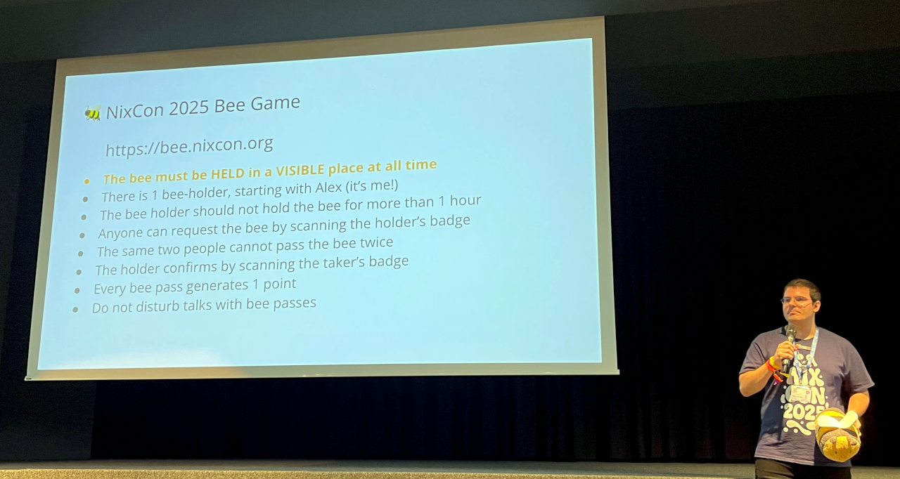 Alex in front of a slide with the bee game rules