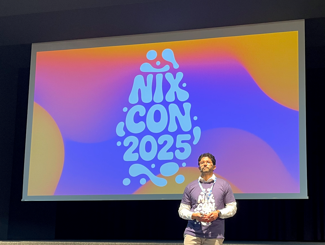 Dr. Farhad Mehta in front of NixCon screen
