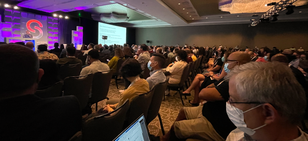 People in the hotel ballroom watching the keynote presentations