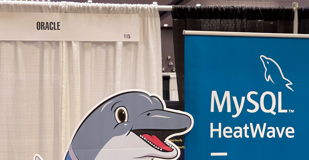 The MySQL booth with an Oracle sign in the background